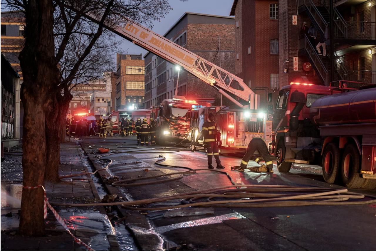 Firefighters in Johannesburg on early Thursday morning. (Shiraaz Mohamed/Reuters)