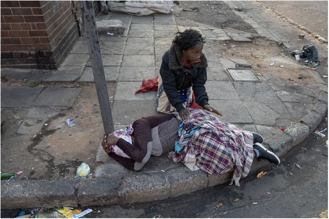 A women holds her head in her hands in Johannesburg. (Shiraaz Mohamed/Reuters)