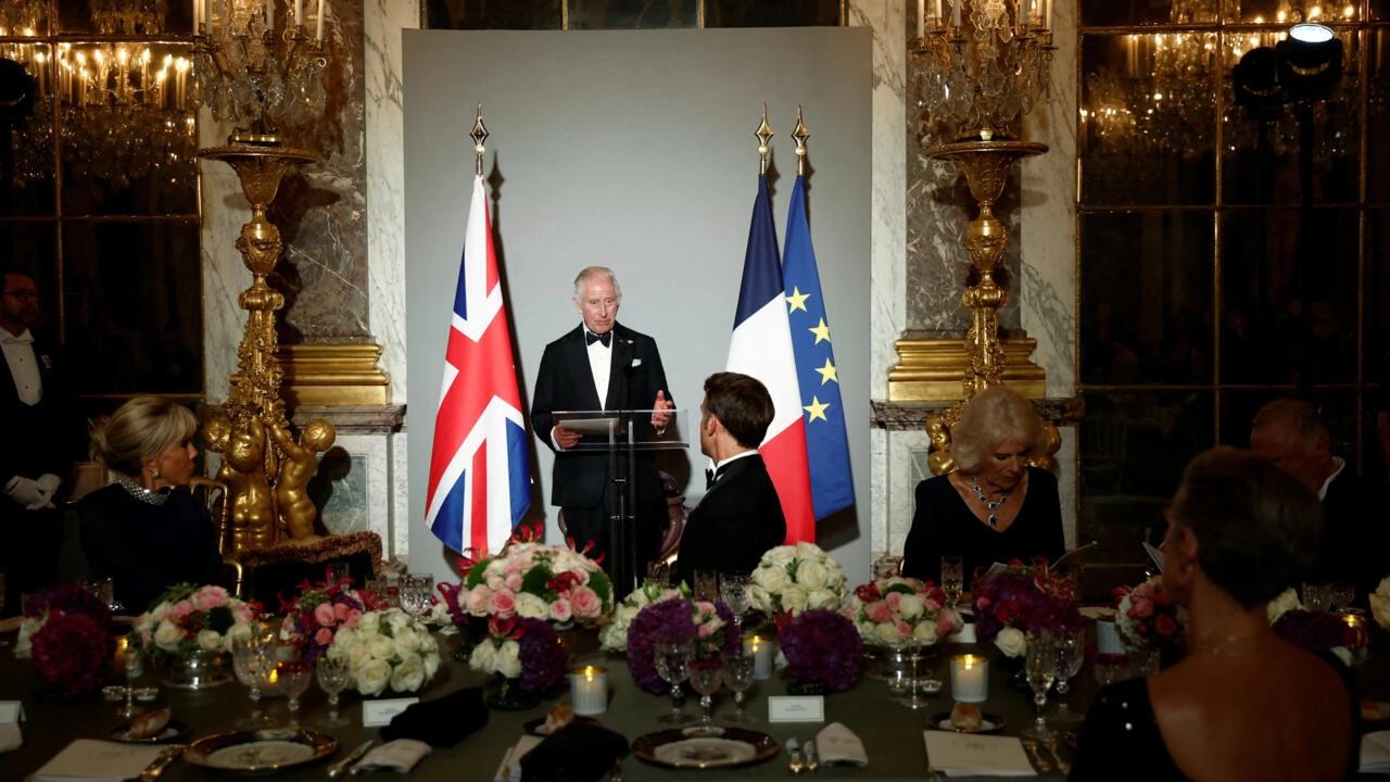 Britain's King Charles III delivers a speech as French president's wife Brigitte Macron, French President Emmanuel Macron and Britain's Queen Camilla listen during a state banquet at the Palace of Versailles, west of Paris, on September 20, 2023