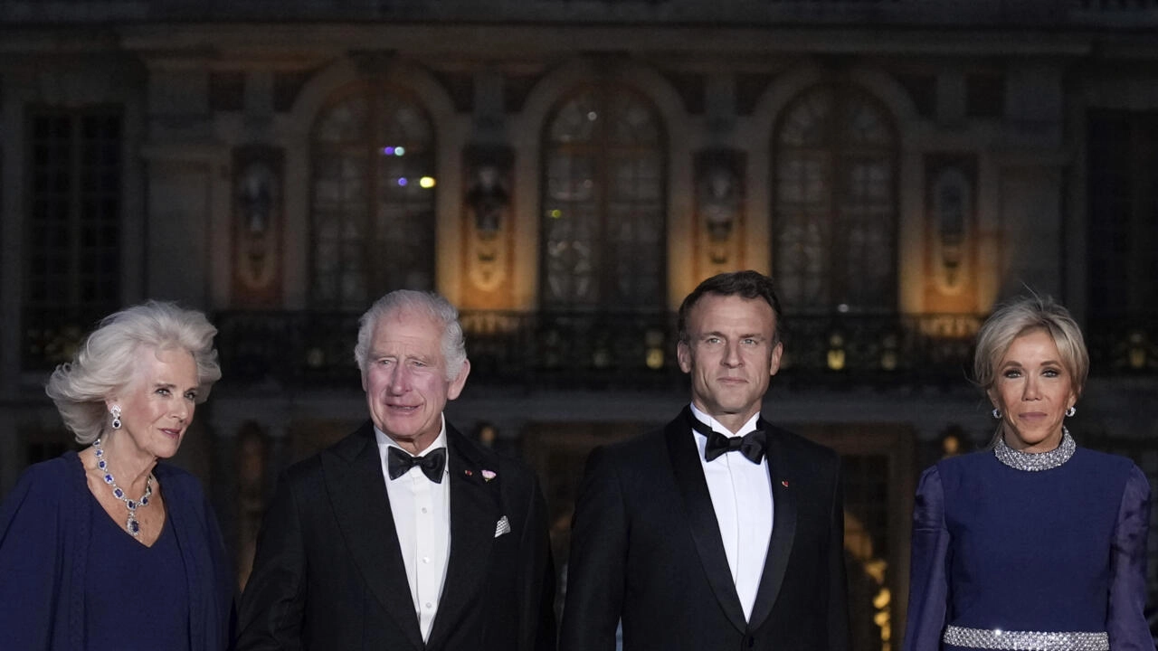 French President Emmanuel Macron, center right, his wife Brigitte Macron, right, Britain's King Charles III, center left, and Queen Camilla arrive for a state dinner, at the Chateau de Versailles, west of Paris, Wednesday, Sept. 20, 2023.
