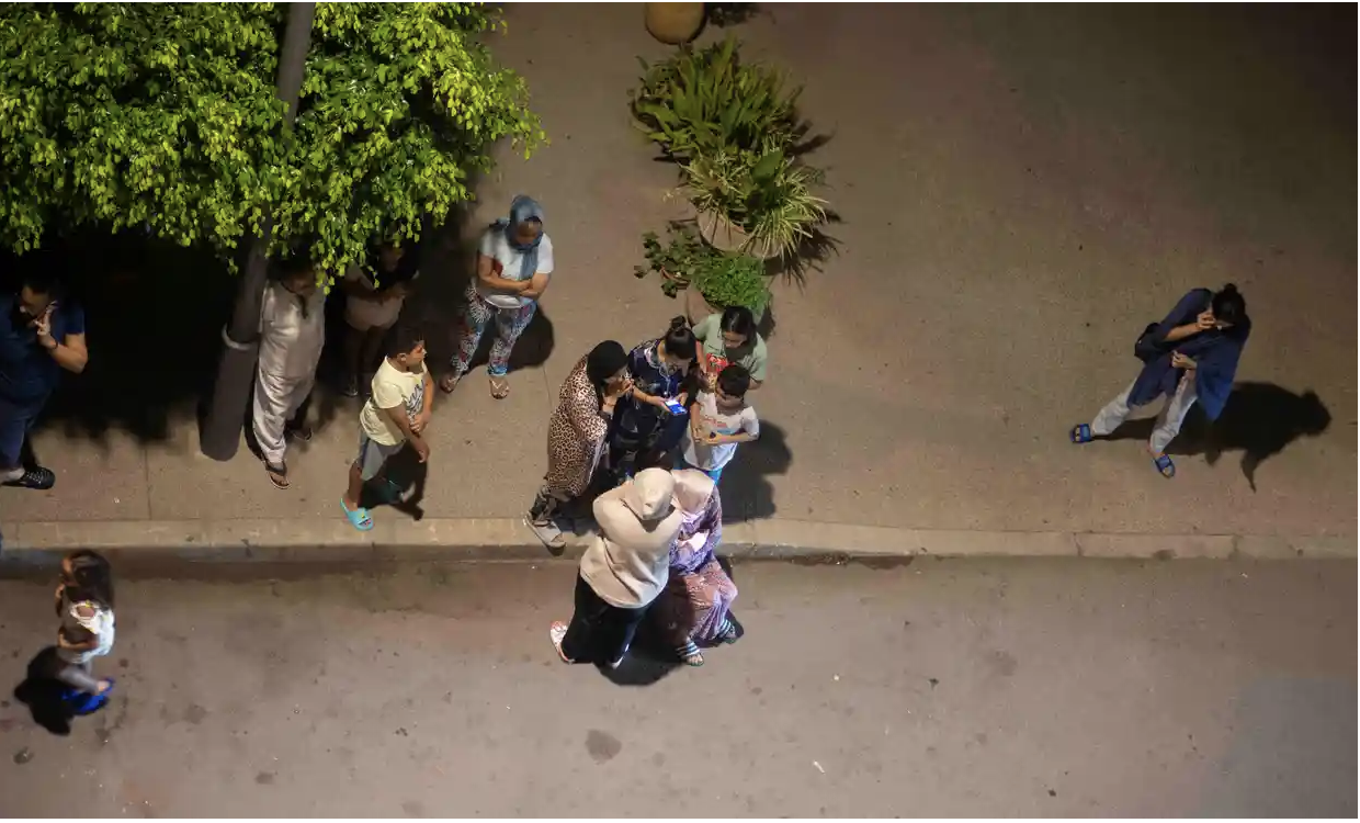 People stand in a street after Rabat was shaken by the quake. Photograph: Mosa’ab Elshamy/AP