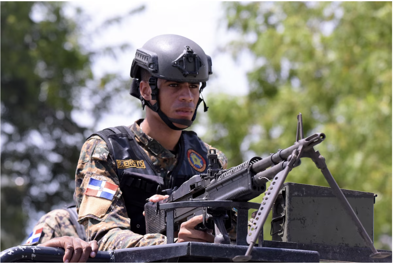  A Dominican soldier mans a rifle at the border in Dajabon last week. (Luis Tavarez/EPA-EFE/Shutterstock)