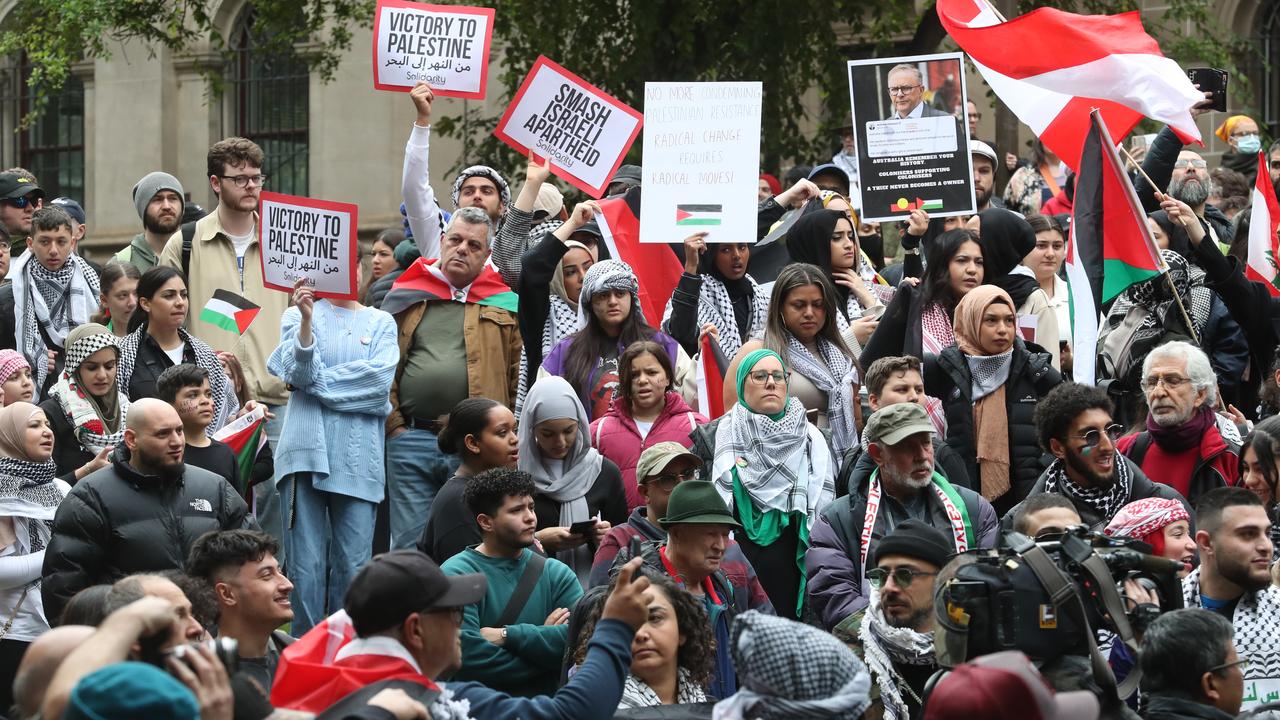 People participate in a rally against the occupation of Palestine and the conflict between Israel and Hamas in Melbourne today. Picture: David Crosling