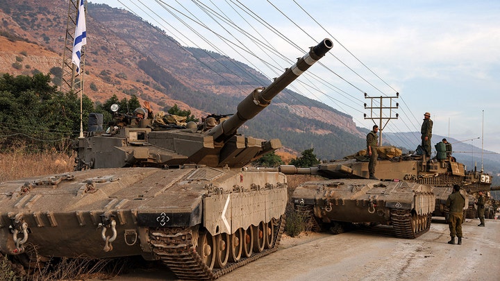 A column of Israeli Merkava battle tanks is amassed in the upper Galilee in northern Israel near the border with Lebanon on Oct. 11, 2023. (JALAA MAREY/AFP via Getty Images)