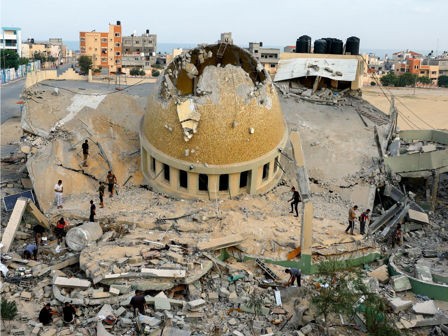 Palestinians inspect a mosque destroyed in Israeli strikes in Khan Younis, in the southern Gaza Strip, October 8, 2023. REUTERS/Ibraheem Abu Mustafa TPX IMAGES OF THE DAY