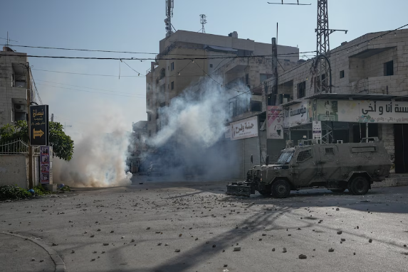 Palestinians clash with Israeli forces following an army raid in the West Bank city of Jenin in January. (Majdi Mohammed/AP)