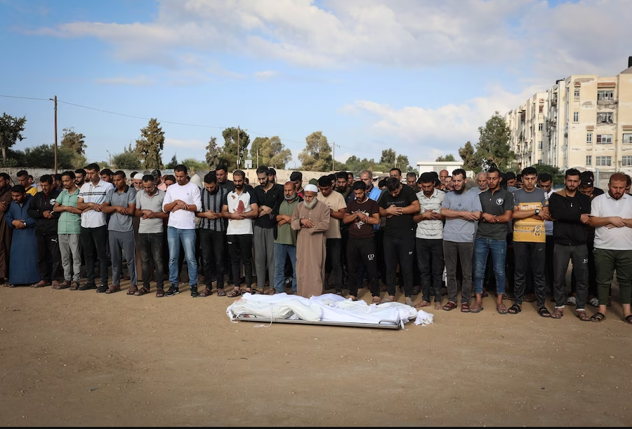 Palestinians pray over the bodies of three members of the Al-Majaida family after their home was hit in an airstrike in Khan Younis, Gaza, on Thursday. (Loay Ayyoub for The Washington Post)
