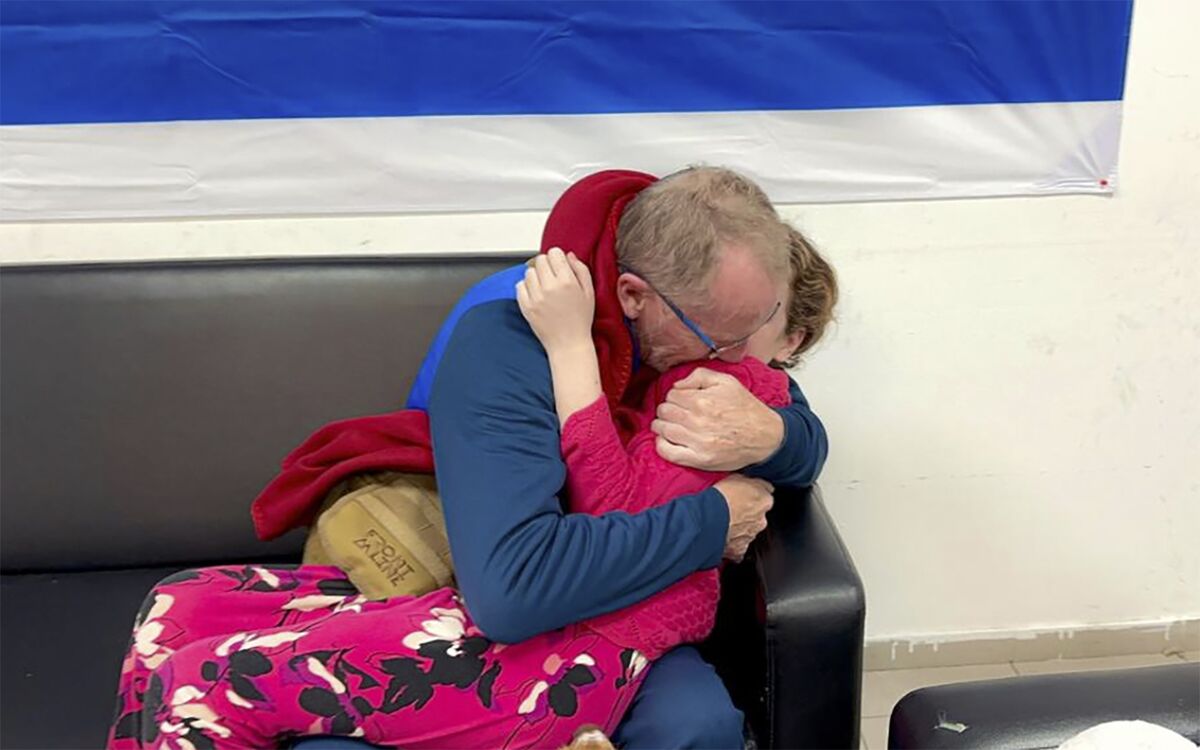 A released hostage reunites with her father in Israel, Nov. 26.Source: The Israeli Army/AP