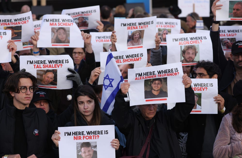People attending a demonstration to show solidarity with Israel and against anti-semitism hold up photographs of hostages taken by Hamas on October 22, 2023 Getty Images