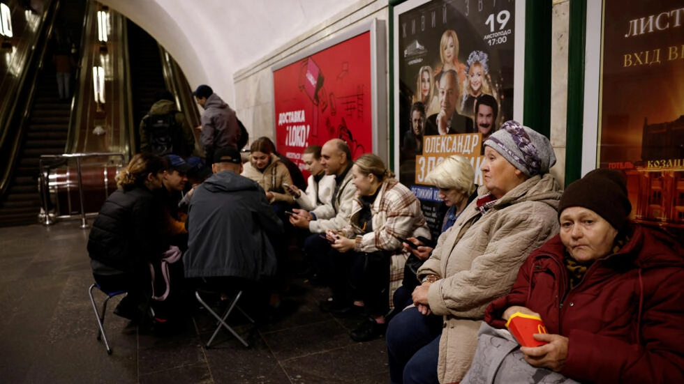 People sit in a metro station to shelter from an air raid in Kyiv, Ukraine on November 11, 2023. © Thomas Peter, Reuters