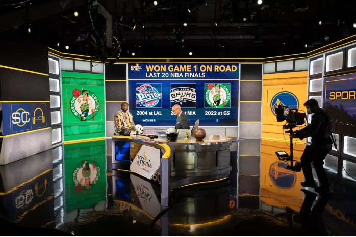 Patrick Beverley, NBA player and analyst for ESPN, speaks on air with Scott Van Pelt at a studio in Washington, DC © Craig Hudson/The Washington Post/Getty Images