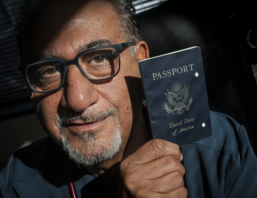 Siavash Sobhani holds one of his expired passports. (Bill O’Leary/The Washington Post)