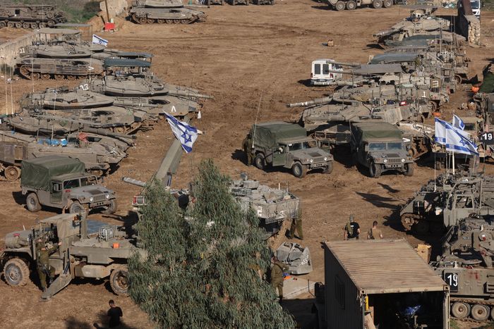 Israeli armored vehicles and troops deployed in southern Israel, near the border with the Gaza Strip, on Friday. PHOTO: GIL COHEN-MAGEN/AGENCE FRANCE-PRESSE/GETTY IMAGES