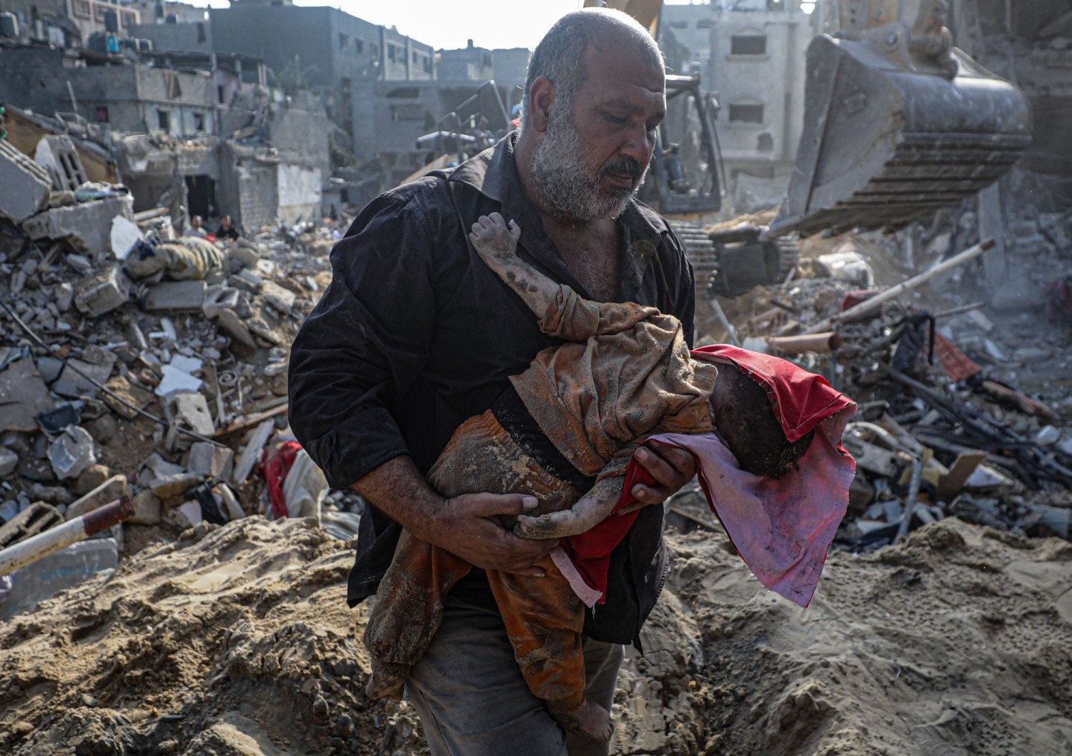 A Palestinian man carries the body of a baby recovered from the rubble of the Jabalia refugee camp one day after an Israeli airstrike hit the area. MOHAMMED SABER/EPA/SHUTTERSTOCK