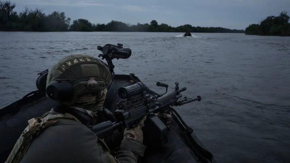 AP Ukrainian soldiers navigate on the Dnipro river by boat