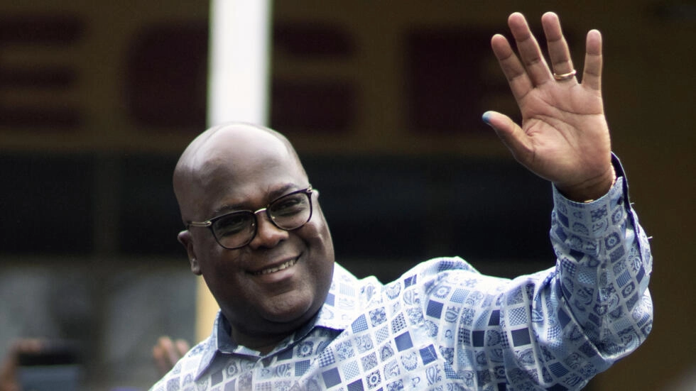 DR Congo's President Felix Tshisekedi waves to his supporters after casting his ballot inside a polling station during the presidential elections in Kinshasa on December 20, 2023. © Mosa'ab Elshamy, AP
