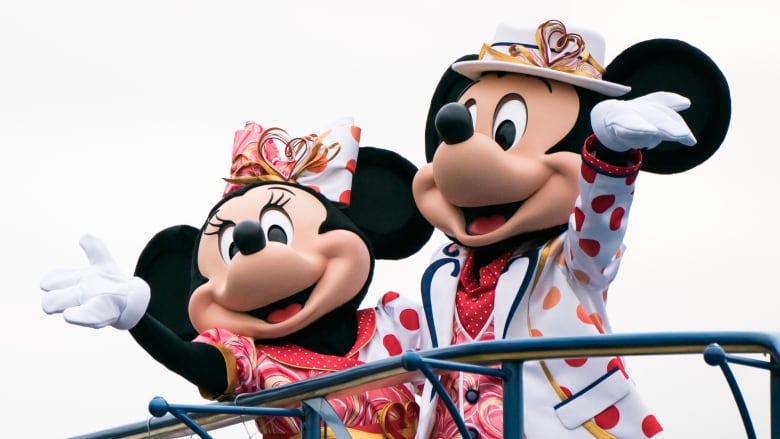 Minnie Mouse and Mickey Mouse performers wave during a press preview for the Minnie Besties Bash! parade at Tokyo DisneySea on Jan. 17, 2023 in Urayasu, Japan. (Tomohiro Ohsumi/Getty Images)