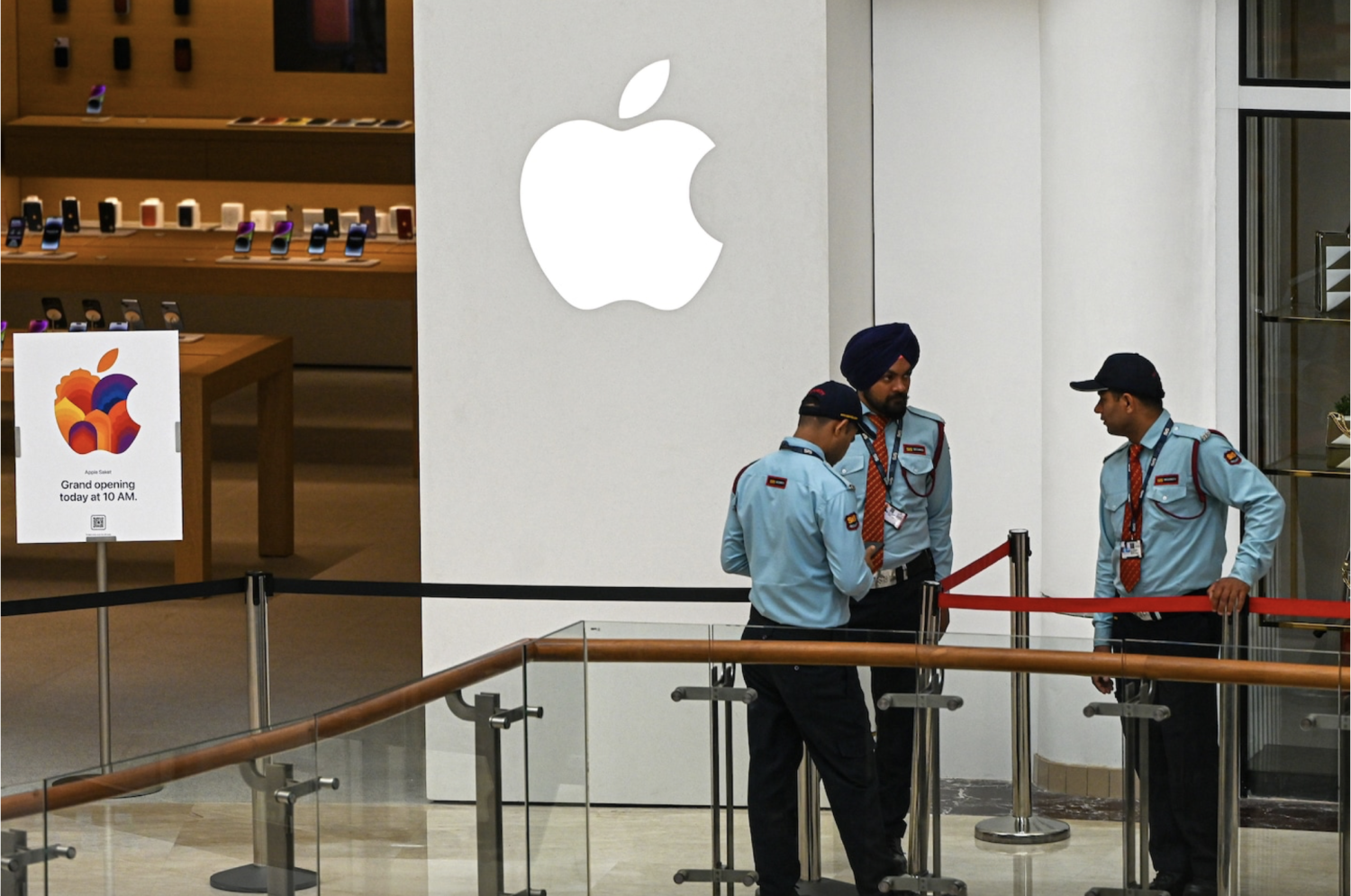 Security personnel prepare for the April opening of a new Apple store in New Delhi. As much as Apple sees growth in India, India has been courting Apple as part of a campaign to create factory jobs. (Prakash Singh/Bloomberg News/Getty Images)