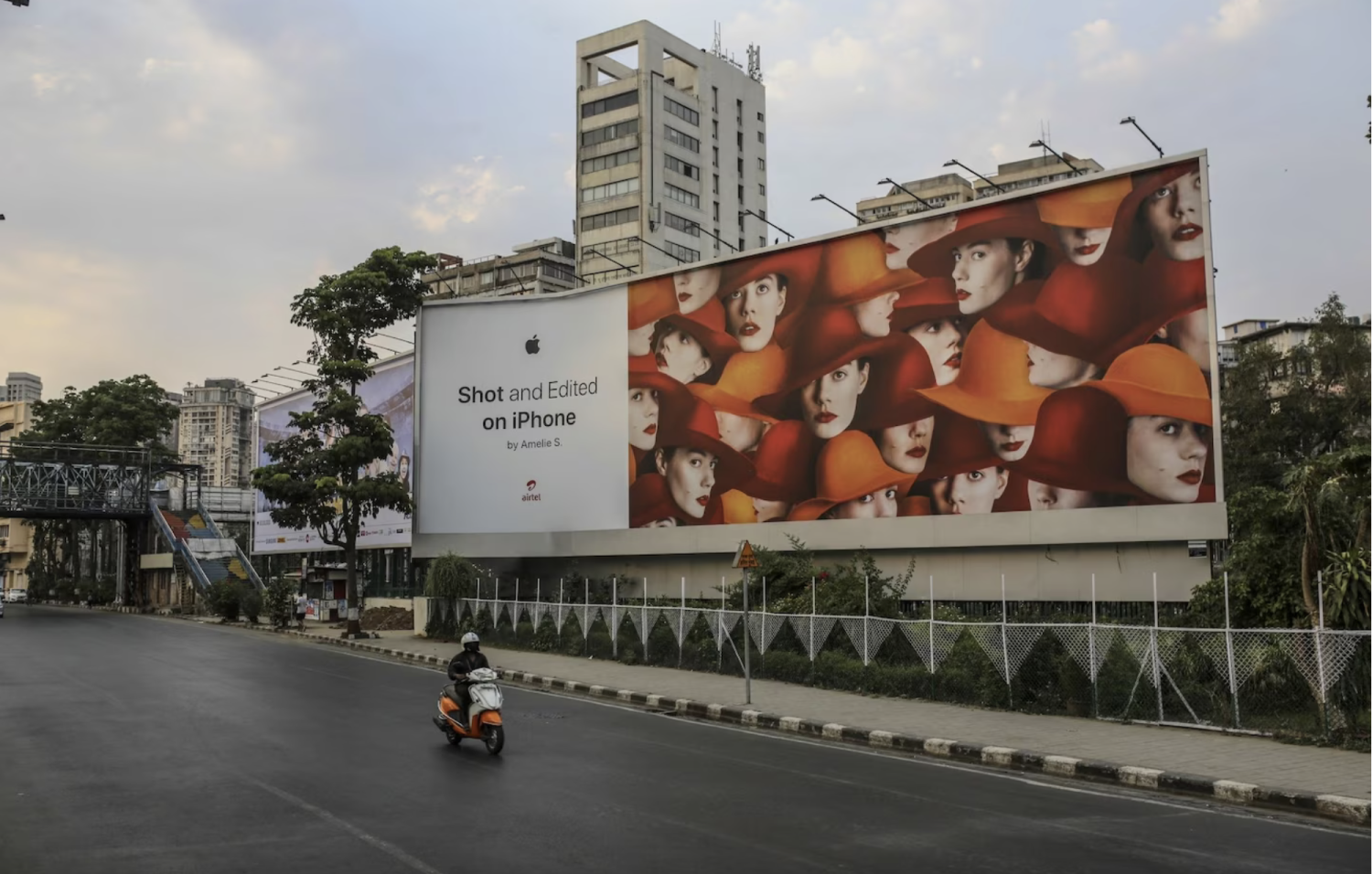 A motorist rides past a billboard for the iPhone in Mumbai. One spyware industry expert said Apple is “treading a very delicate line” with India, as the company seeks to balance its mission of protecting privacy with avoiding putting an important market at risk. (Dhiraj Singh/Bloomberg News)