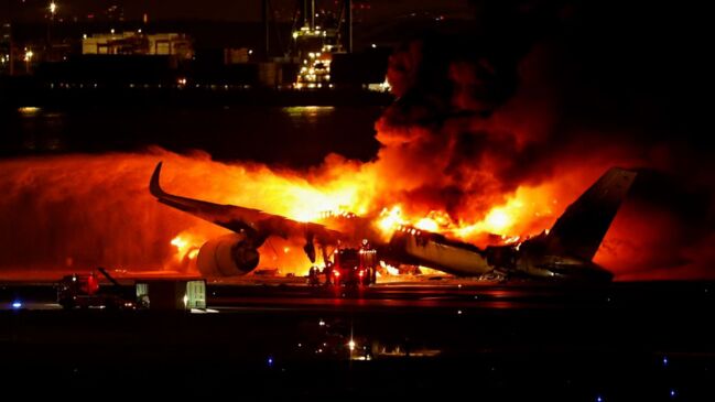 Japan Airlines plane bursts into flames at Tokyo airport with 379 people on board, all escape