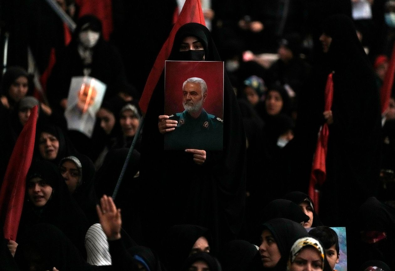 A woman held up a poster of Qassem Soleimani, commander of the Islamic Revolutionary Guard Corps’ elite Quds Force, who was killed by a U.S. airstrike. PHOTO: VAHID SALEMI/ASSOCIATED PRESS