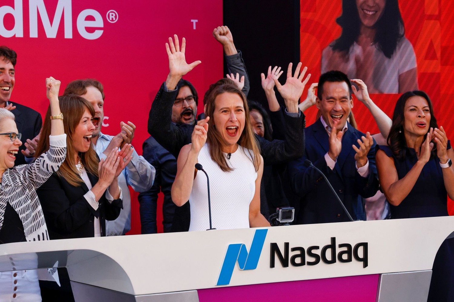 Anne Wojcicki of 23andMe, center, remotely rang the NASDAQ opening bell the day the company went public in 2021. PETER DASILVA/REUTERS