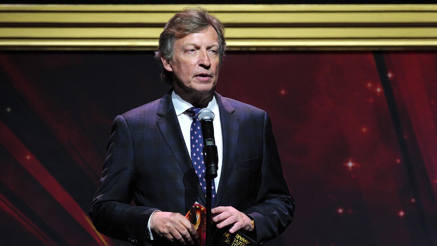 Nigel Lythgoe presents an award at the 36th College Television Awards, presented by the Television Academy Foundation at the Skirball Cultural Center in Los Angeles on Thursday, April 23, 2015.  Vince Bucci/Invision/AP