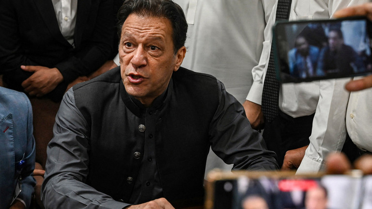 Pakistan's former prime minister, Imran Khan gestures after arriving at a registrar office in Lahore High court to sign surety bonds for bail in various cases, in Lahore on July 3, 2023. ©  Arif ALI / AFP