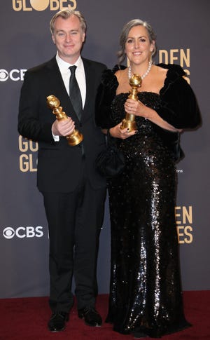 'Oppenheimer' producers Christopher Nolan, left, and Emma Thomas pose with their Golden Globes. Dan MacMedan, USA TODAY