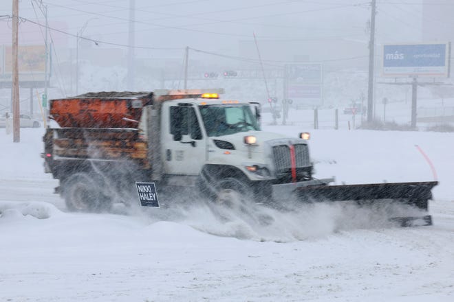 A snowplow clears the parking lot outside the Horizon Family Restaurant on Jan. 8, 2024, in Sioux City, Iowa. Joe Raedle, Getty Images