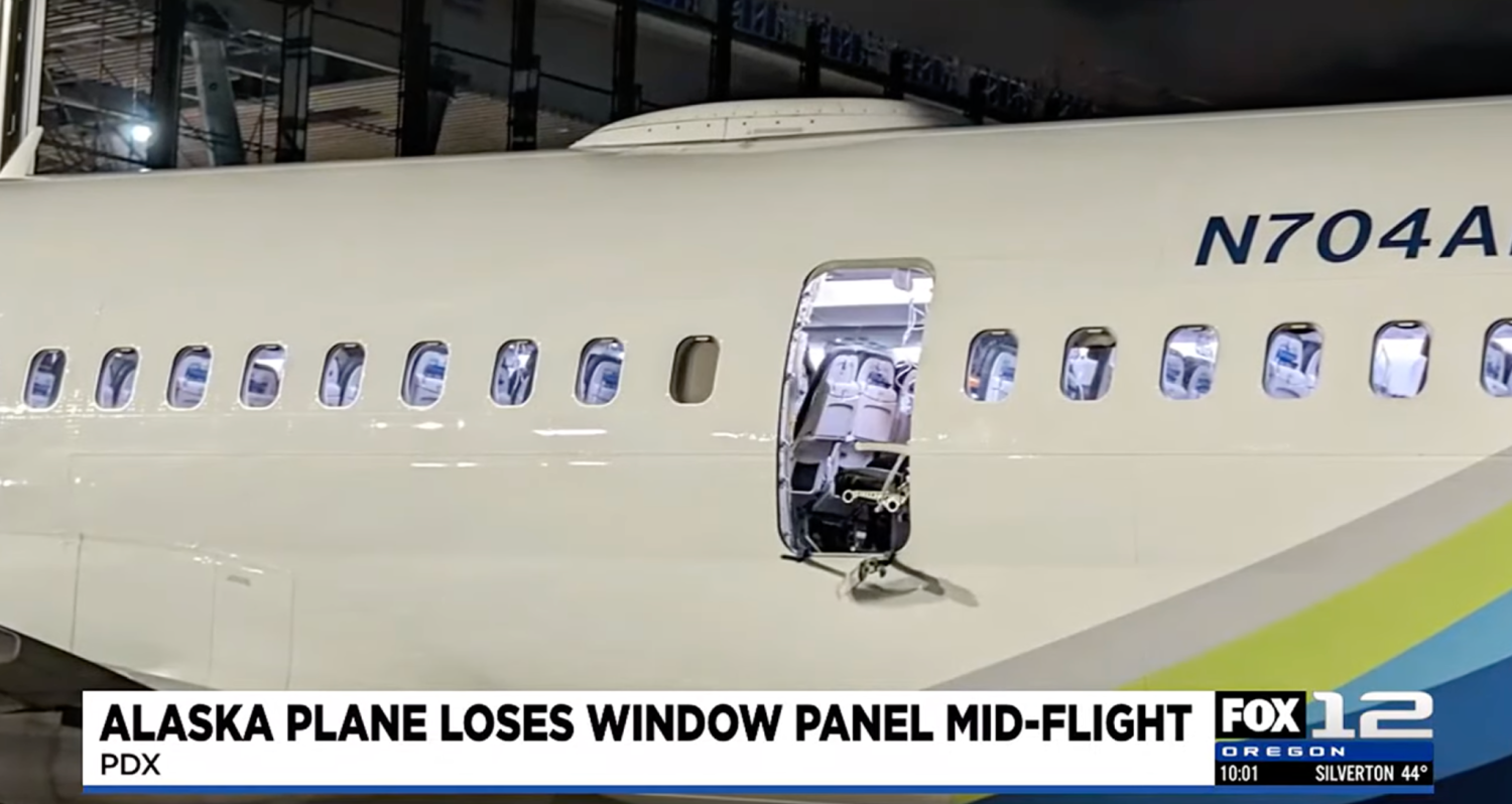 The hole on the side of the plane is seen after the Alaskan Airlines flight returned to Portland on Friday night.