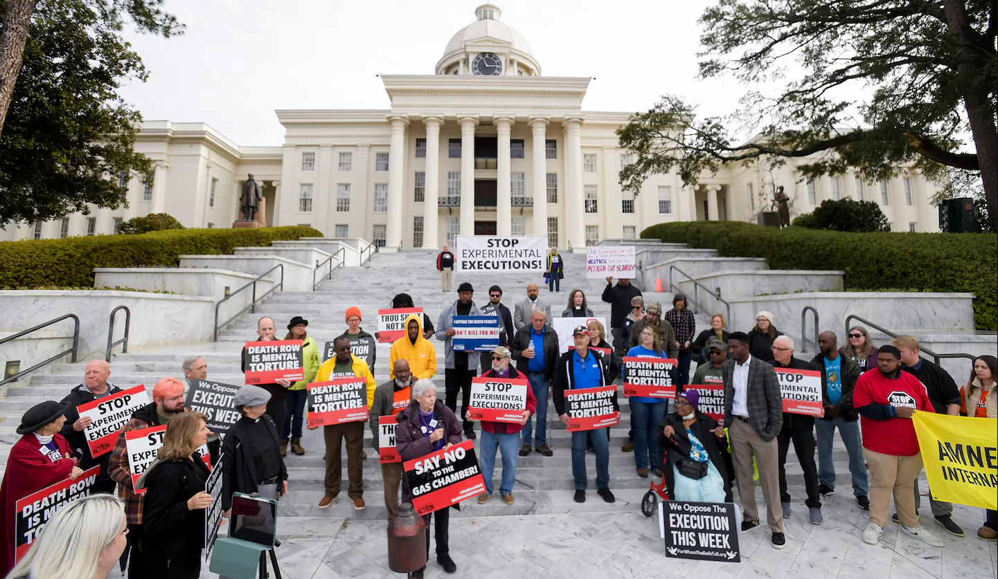 Nearly 100 protesters gather at the state capitol building in Montgomery, Ala., on Tuesday, Jan. 23, 2024, to ask Gov. Kay Ivey to stop the planned execution of Kenneth Eugene Smith. (Mickey Welsh/The Montgomery Advertiser via AP)