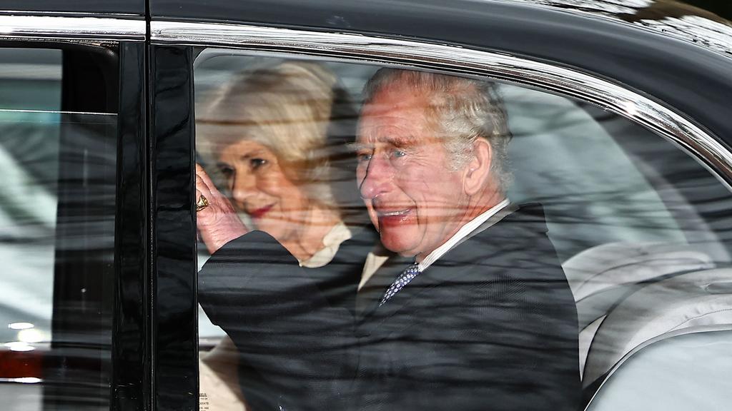 Britain's King Charles III and Britain's Queen Camilla wave as they leave by car from Clarence House, travelling to Buckingham Palace, in London on February 6, 2024. (Photo by HENRY NICHOLLS / AFP)