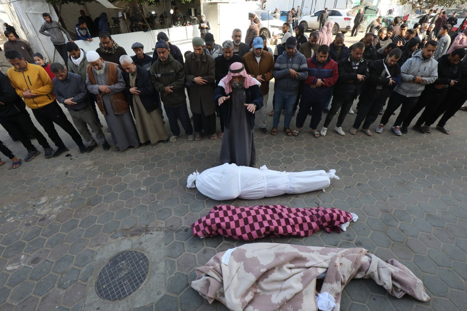 Palestinians receiving their relatives’ bodies for burial from a hospital in Gaza. ALI HAMAD/ZUMA PRESS