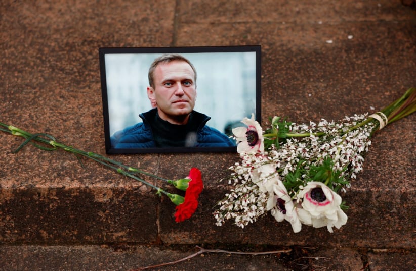 Flowers and a portrait of Russian opposition leader Alexei Navalny are seen near the Russian embassy in Paris, France, February 16, 2024 (photo credit: REUTERS/GONZALO FUENTES)