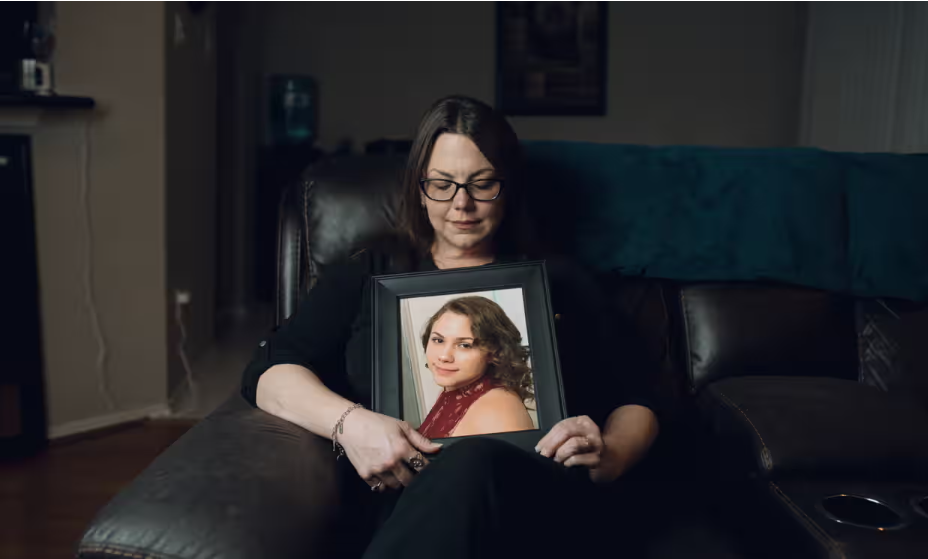 View image in fullscreen Robyn Cory at home in Houston with a photo of her daughter Kristen. ‘My message for other parents is: don’t let your kids have social media,’ says Cory. Photograph: Tola Olawale/The Guardian