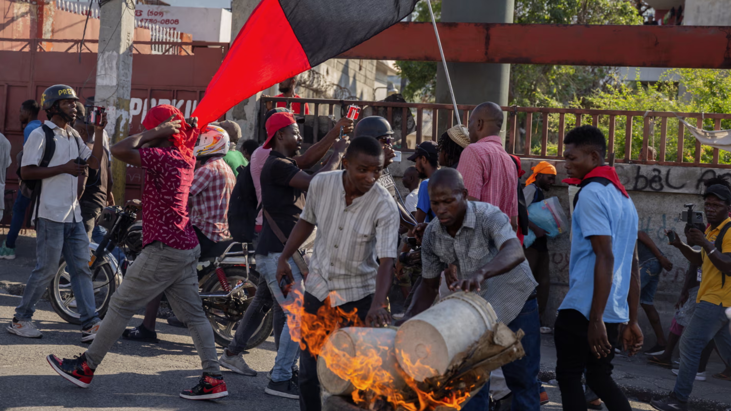 People set tyres on fire during a demonstration demanding the resignation of the Haitian prime minister, Ariel Henry, in Port-au-Prince on 7 March. Photograph: Anadolu/Getty Images