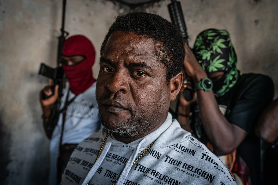 Gang leader Jimmy “Barbecue” Chérizier with G9 gang members in the Delmas 3 area of Port-au-Prince, Haiti, on Feb. 22. (Giles Clarke/Getty Images)