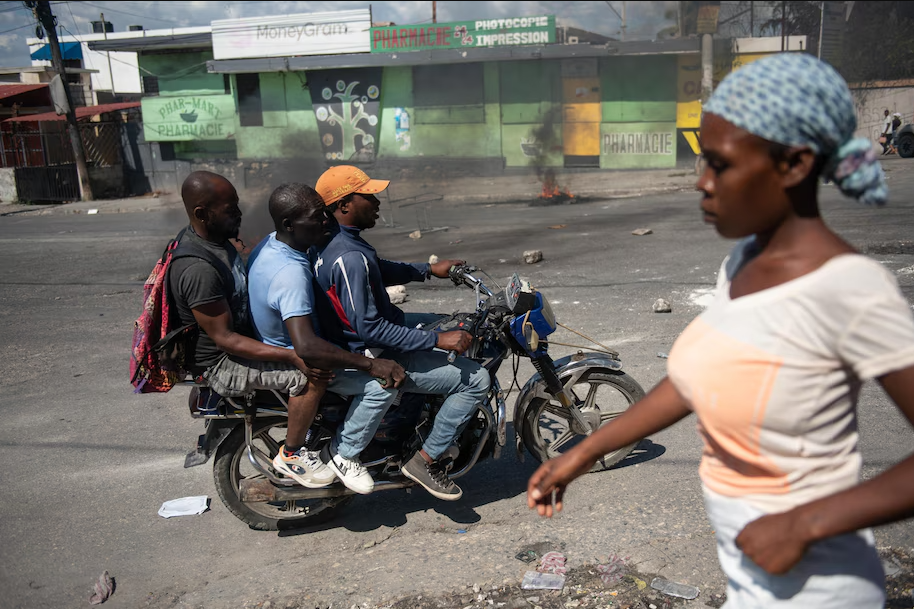 People travel by motorcycle in Port-au-Prince. (Johnson Sabin/EPA-EFE/Shutterstock)