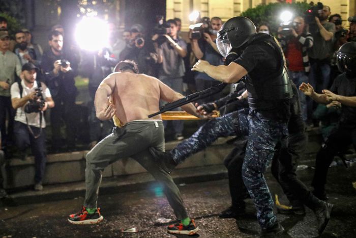A protester clashed with riot police during a demonstration against the bill near Parliament in Tbilisi, Georgia. PHOTO: DAVID MDZINARISHVILI/SHUTTERSTOCK