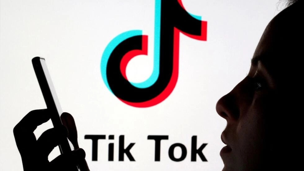 File photo: A person holds a smartphone as in front of the TikTok logo, November 7, 2019. © Dado Ruvic, Reuters