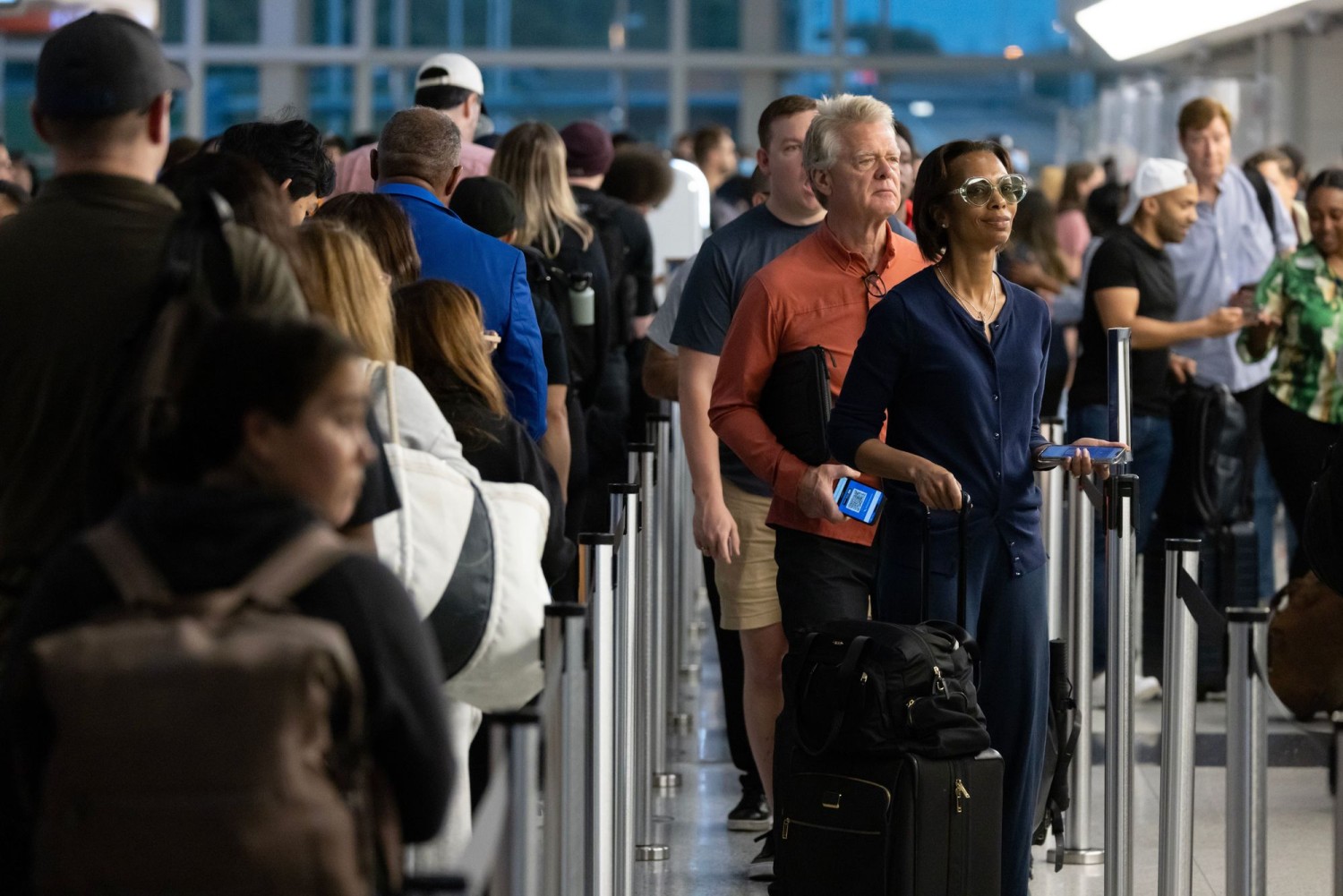 Record numbers of travelers are pouring into airports ahead of the Fourth of July holiday, which could translate into much longer lines. MICHAEL REYNOLDS/EPA/SHUTTERSTOCK