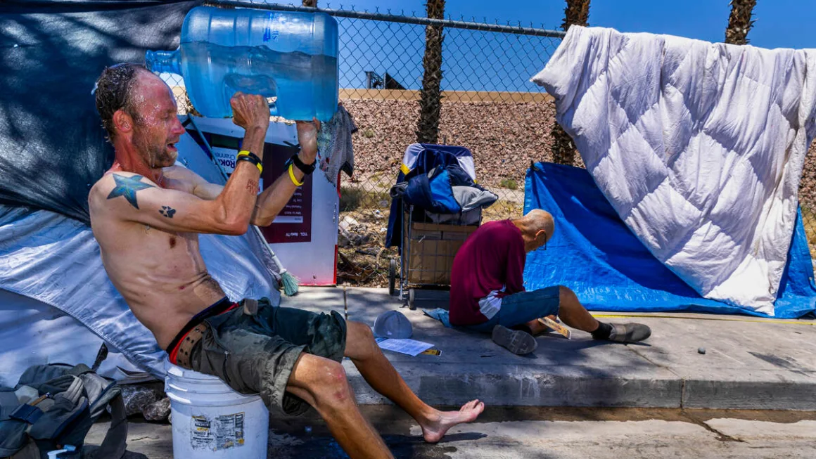 Milton John Scott III, who is unhoused, pours a jug of water on his head to escape the heat and wash up at his shelter in Las Vegas, Nevada on June 5. L.E. Baskow/Las Vegas Review-Journal/Tribune News Service/Getty Images