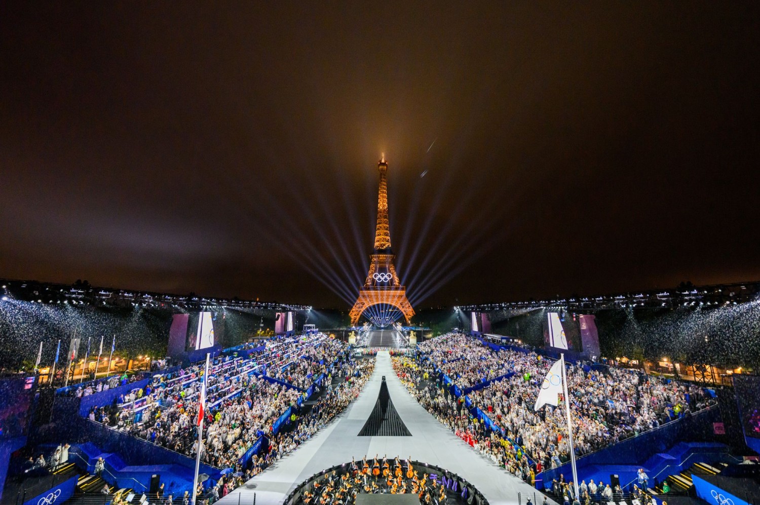 The Opening Ceremony culminated in a laser show and Céline Dion singing Edith Piaf’s ‘Hymne à l’Amour’ from a stage nestled at the center of the Eiffel Tower. FRANCOIS-XAVIER MARIT/PRESS POOL