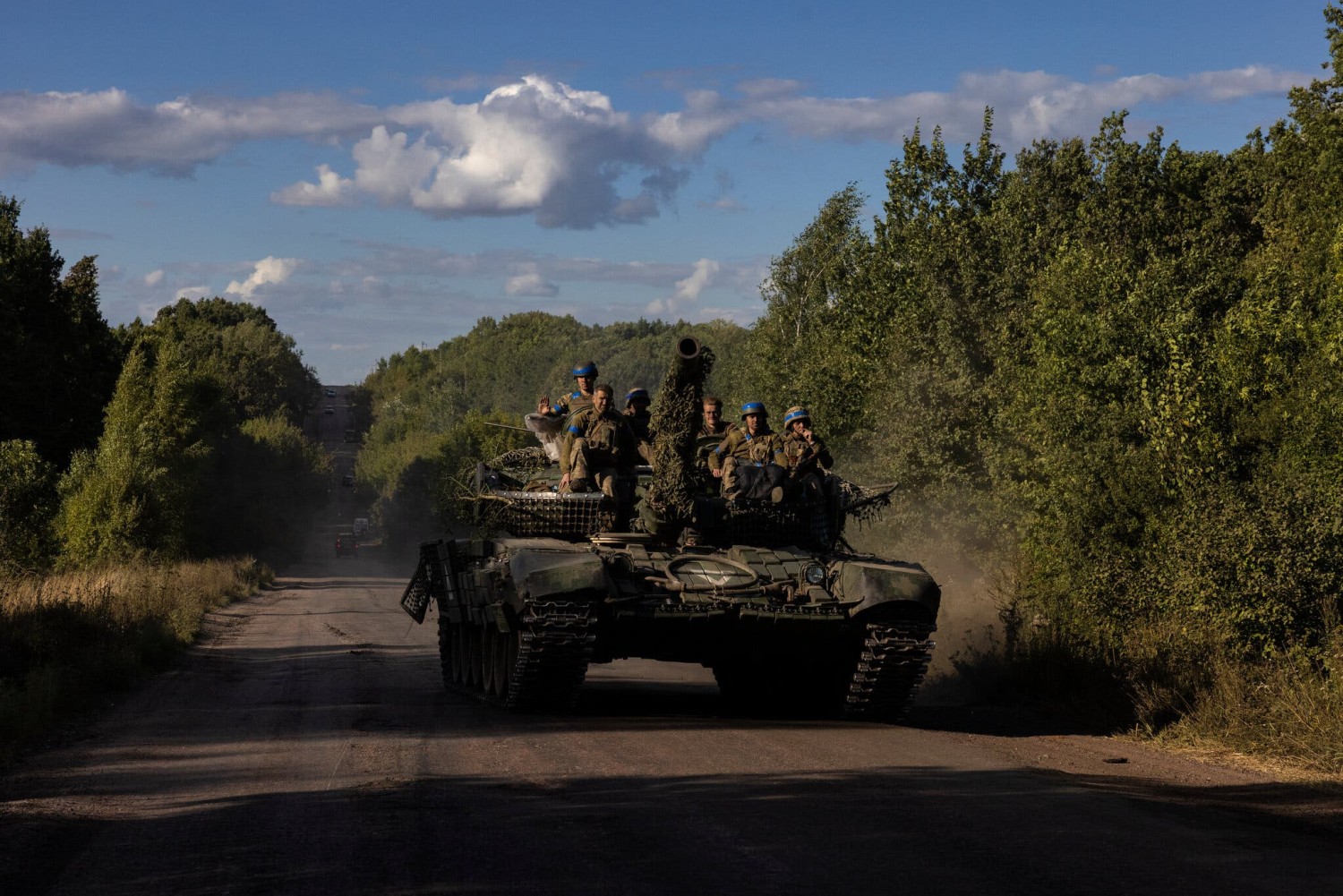 Ukrainian troops riding atop a tank on the main road near the Russian border in the Sumy region of Ukraine last week.Credit...David Guttenfelder for The New York Times