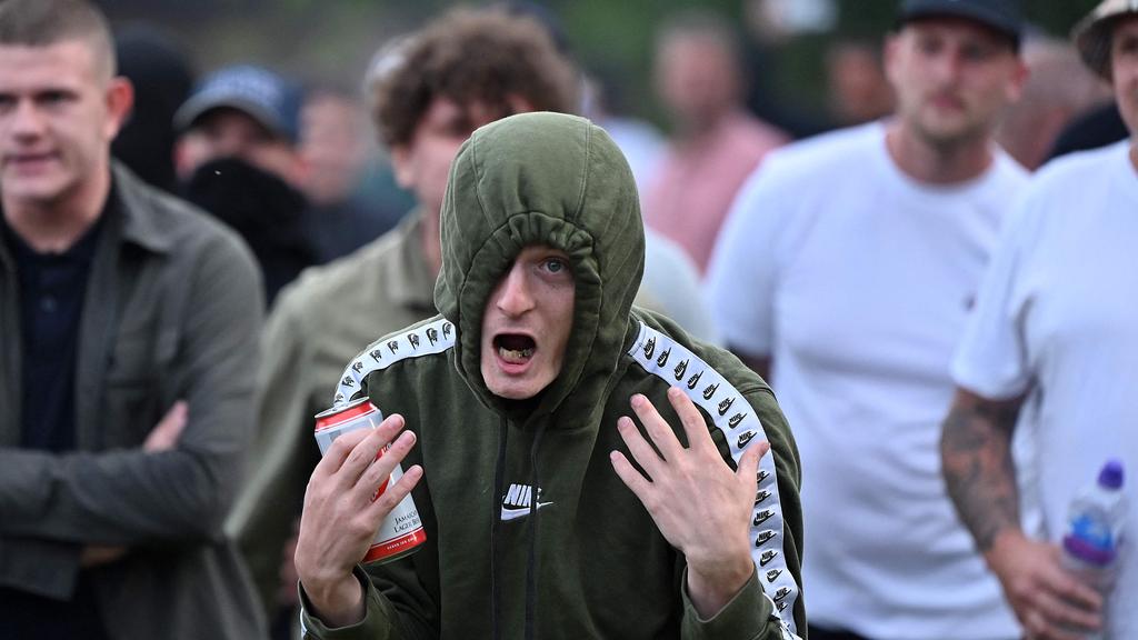 A protester gestures at riot police as clashes erupt in Bristol on August 3, 2024. Picture: AFP