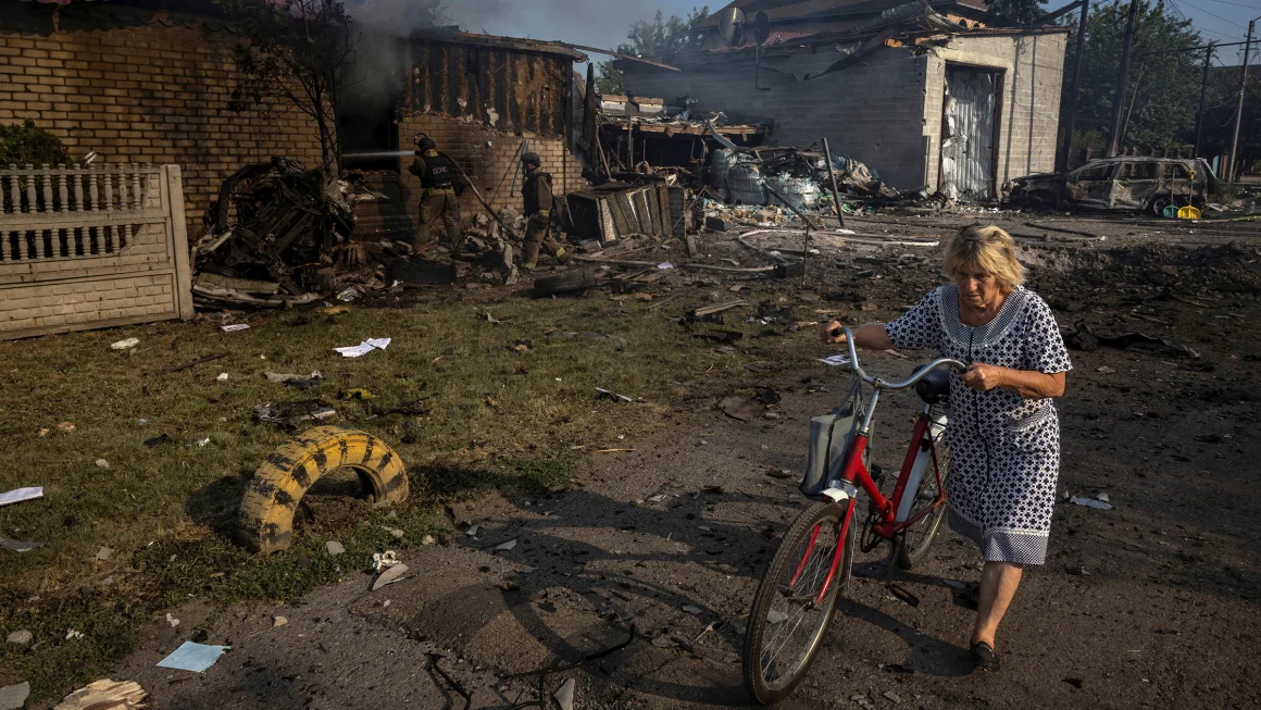 A woman walks past a house that was destroyed after a Russian strike on a residential area in Pokrovsk, Ukraine, on August 3, 2024. Thomas Peter/Reuters