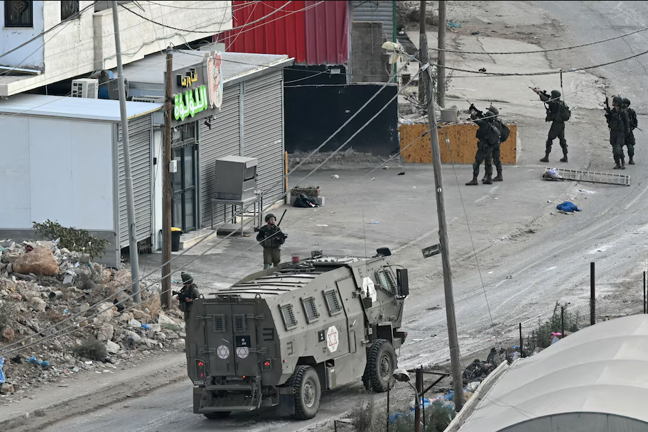 Israeli soldiers conduct a raid on the al-Fara'a camp near Tubas on Wednesday. (Ronaldo Schemidt/AFP/Getty Images)