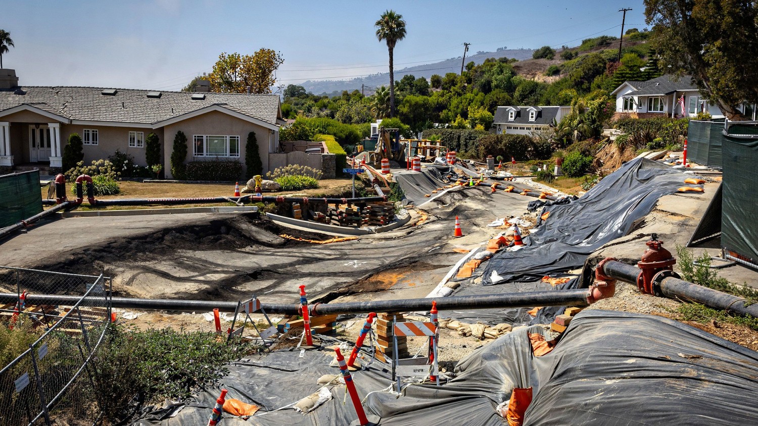 Damage from land movement is seen near the Portuguese Bend Community in Rancho Palos Verdes, California, where an evacuation warning was issued and electricity was cut on Sunday. Jason Armond/Los Angeles Times/Getty Images