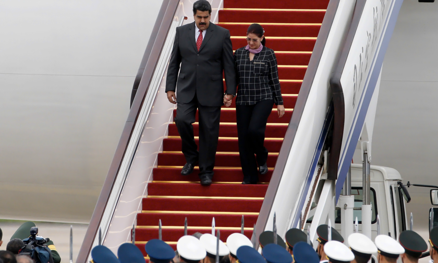 Maduro and first lady Cilia Flores disembarking plane in Beijing in 2015. Photograph: Ng Han Guan/AP